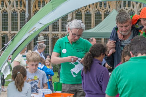 group of adults and children at Wildlife Discovery Day at Forde Abbey cutting out animal pictures