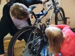 Two people examine a bicycle