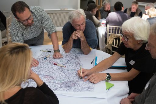 people sat around looking a at a map at the catchment Communities Conference