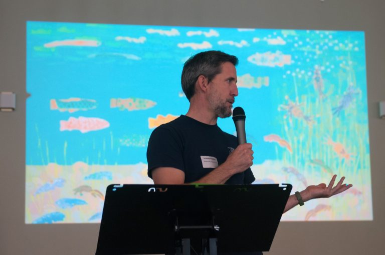 Tom Lindsay talking on a stage