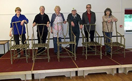 five Hedgerow chairs with people stood behind on a stage
