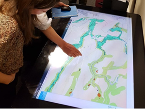A person using a large interactive map table