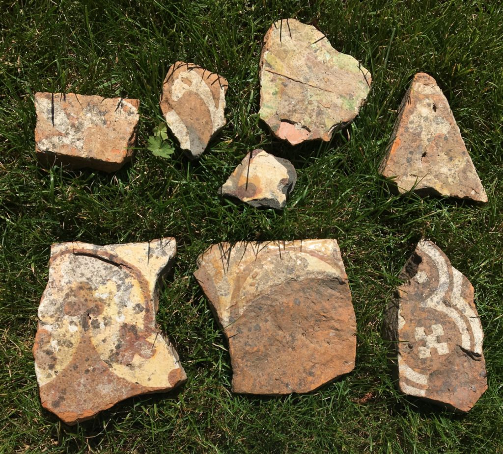 Floor tile fragments on which you can make out some of the original designs