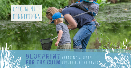 woman and young boy looking at a fishing net stood beside the river