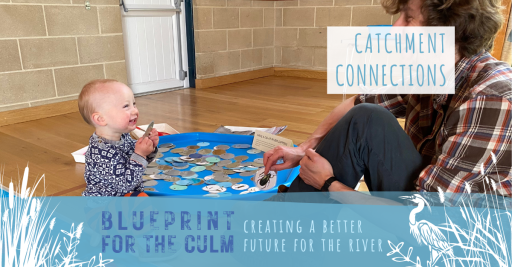 small child sat with a man smiling playing with small animal discs