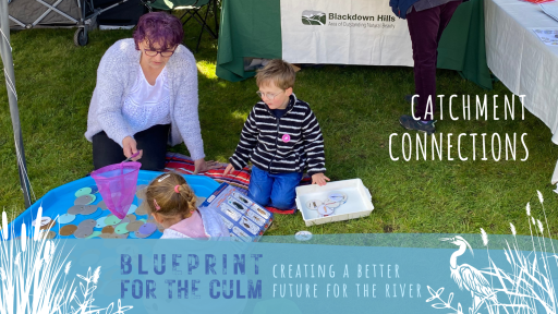 lady with two young children playing a fish game in a blue tray
