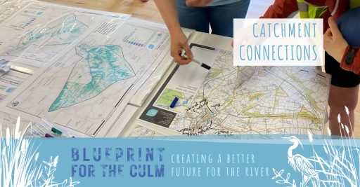 two people stood looking at some maps