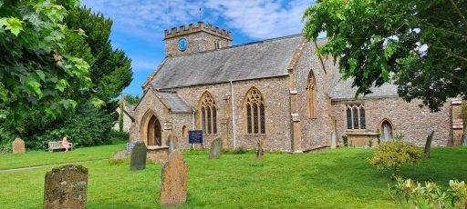front entrance photo of St Mary's Church, Hemyock showing grave stones