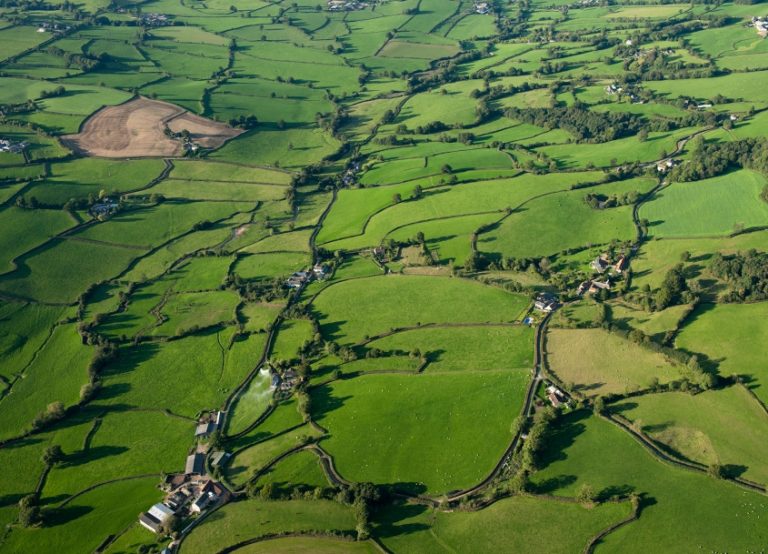 An aerial photograph showing fields and hedgerows and other landscape features.