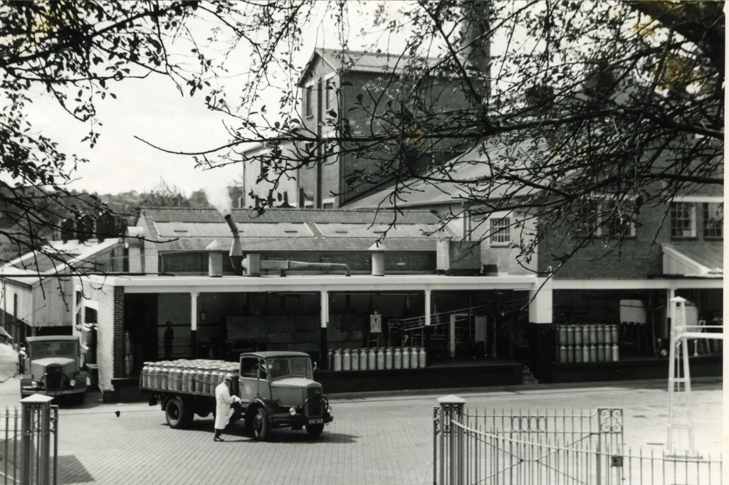 A black and white historic photograph of a mil factory.