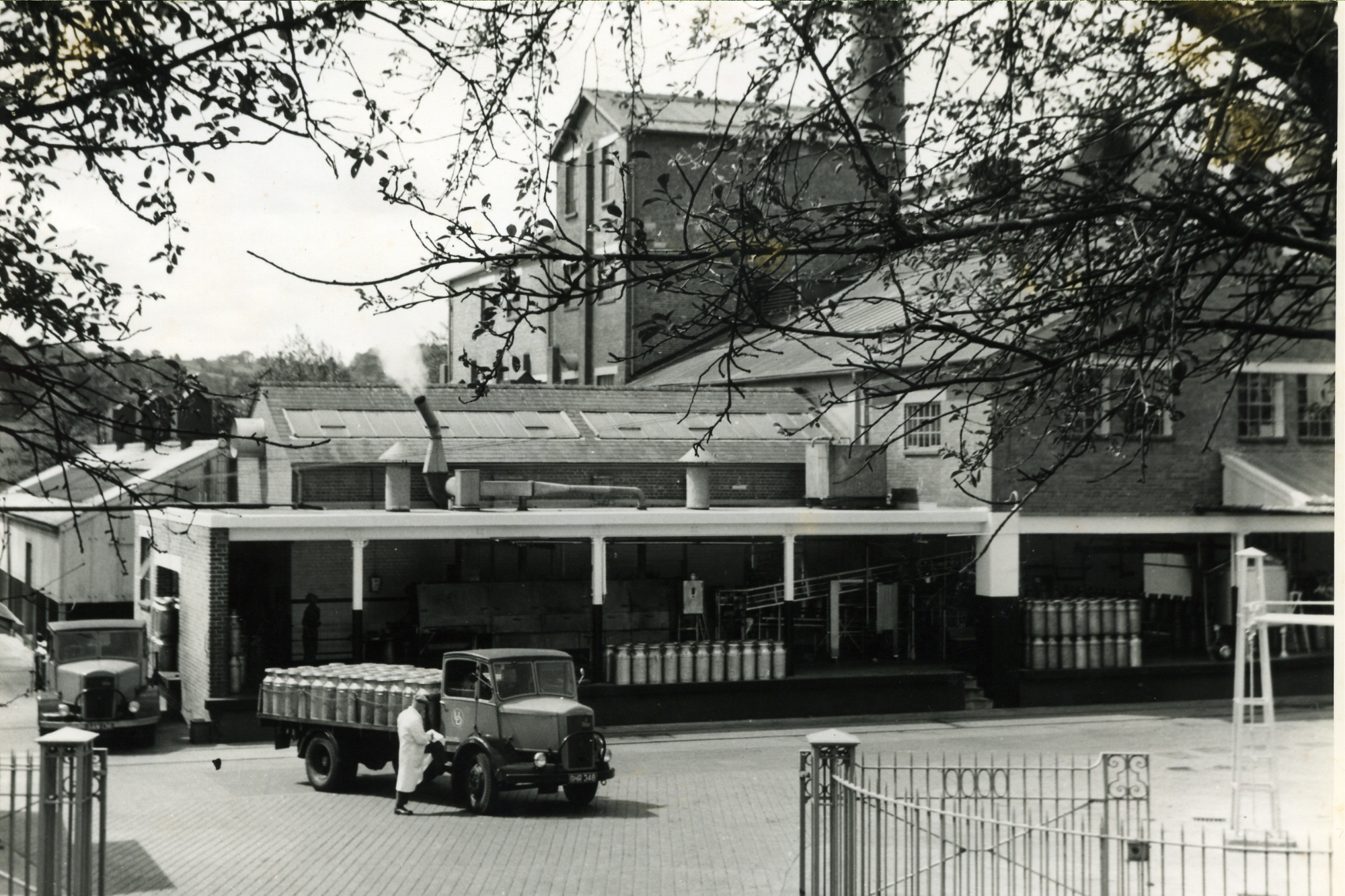 A black and white historic photograph of a mil factory.